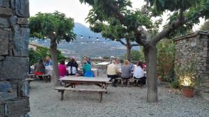 a group of people sitting around a picnic table at L'Albadu in Corte