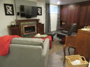 a living room with a couch and a television at StudioOne Pebble Beach in Powell River