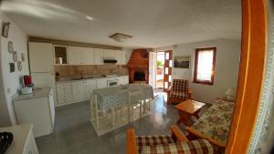 una cucina e un soggiorno con tavolo e sedie di Villa La Favola a Ischia