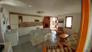 a kitchen and living room with a table and chairs at Villa La Favola in Ischia