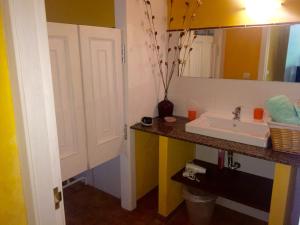 a bathroom with a sink and a mirror at Los Tres Soles in Silleda +33 photos
