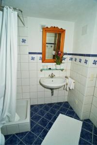 a bathroom with a sink and a toilet and a shower at Villa 17 in Gaschurn