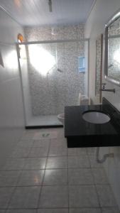 a bathroom with a shower and a sink and a toilet at Pousada Da Restinga in Cabo Frio
