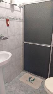 a bathroom with a shower and a sink at Pousada Da Restinga in Cabo Frio