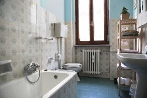 a bathroom with a tub and a toilet and a sink at Goga&Romeo in Pesaro