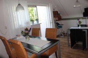 a living room with a table and chairs and a kitchen at Hof van Lutten in Lutten