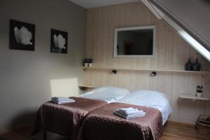 a bedroom with a bed with a mirror on the wall at Hof van Lutten in Lutten