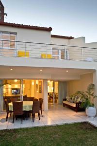 a house with a patio with a table and chairs at D3 Sea Lodge - by Stay in Umhlanga in Durban