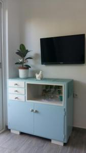 a blue cabinet with a tv on top of it at House Lavanda in Rab
