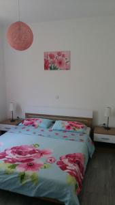 a bedroom with a bed with flowers on it at House Lavanda in Rab