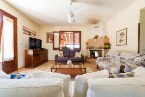 a living room with two couches and a tv at Sicilian Paradise in Castelvetrano Selinunte