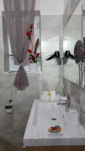 un bagno con un lavandino bianco e uno specchio di La Casa del Sole a Vico Equense