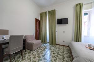 a hotel room with a desk and a bed and a chair at Bed & Breakfast Antonello in Salerno