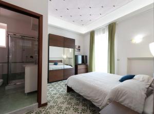 サレルノにあるBed & Breakfast Antonelloのベッドルーム(大型ベッド1台付)、バスルームが備わります。