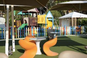 a childrens playground with a play park with a colorful playground at Hotel Sporting in Alba Adriatica