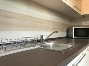 a kitchen with a sink and a microwave at Great Home in Pécs