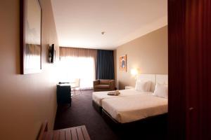Säng eller sängar i ett rum på Porto Antas Hotel
