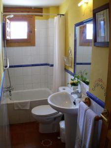 a bathroom with a sink and a toilet and a tub at Casa rural Estrella Polar II in Arcones