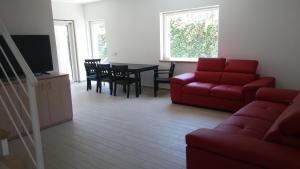 a living room with a red couch and a table at Villa Clale in Montauro