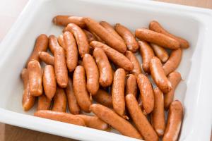 a white container filled with lots of sausages at Hotel Route-Inn Fuji Chuo Koen Higashi in Fuji +44 photos
