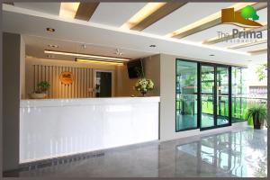 a lobby with a white counter in a building at The Prima Residence - SHA Certificate in Bangkok