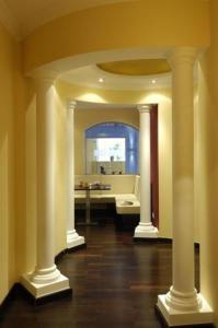 a room with a bathroom with a sink and columns at Posthotel Rattenberg in Rattenberg