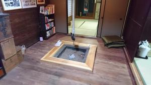 a pool of water in the middle of a room at Guesthouse Okagesan in Hongu