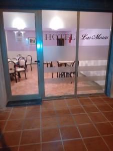 a view of a dining room through a glass door at Hotel Las Moras in La Rioja