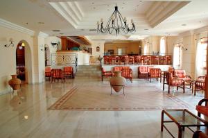 a large room with tables and chairs and a dining room at Hotel Navarone in Petrochori