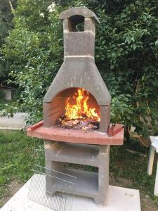 a stone oven with a fire inside of it at Patty House in Colico