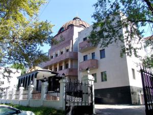 a building with a fence in front of it at Ali Hotel in Khabarovsk