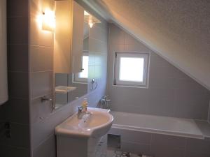 a bathroom with a sink and a bath tub at Natasa Apartments in Jezerce +64 photos