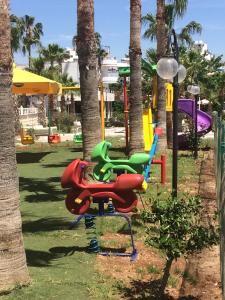 a playground with colorful chairs in a park at Admiral Hotel in Kizkalesi
