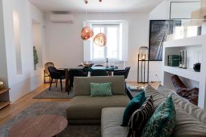 a living room with a couch and a table at Flora Chiado Apartments in Lisbon