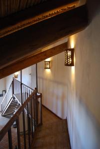 a staircase in a building with lights on the wall at B&B Charme Sa Pardina in Orroli