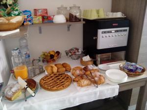 a table with bread and pastries and a coffee maker at B&B Peschici 4 Stagioni in Peschici