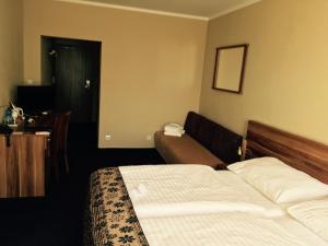ein Hotelzimmer mit einem Bett und einem Sofa in der Unterkunft Hotel Victoria in Martin