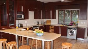 a kitchen with a island with a bowl of fruit on it at Go Wild Resort in Xai-Xai