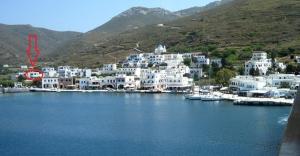 a large group of white buildings in a harbor at Georgia Studios in Katapola