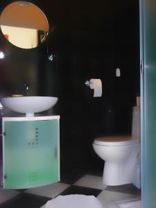 a bathroom with a sink and a toilet and a mirror at u Bozeny pokoje in Dźwirzyno