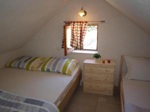 a small bedroom with a bed and a window at Vacation Home Friday in Korčula