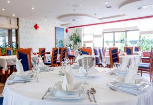 a dining room with white tables and chairs at Hotel Bosna 1 in Sarajevo