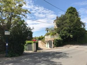 a street with a house and trees on the side of the road at Villa Lorraine in Vence