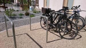 two bikes parked in a rack in front of a building at Maison am Liesingbach in Vienna