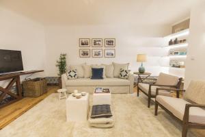 a living room with a couch and a tv at LovelyStay - Downtown Magnificent Flat in Lisbon
