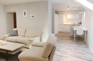 a living room with a couch and a table at Cathedral Sq. Apartment - Odminiu Str. in Vilnius