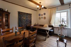 a dining room with a table and chairs and a dining room at Divas Istabas in Saldus