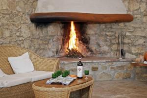 a bottle of wine on a table in front of a fireplace at Agriturismo Testalepre in Greve in Chianti
