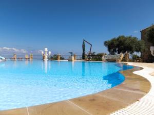 a large swimming pool with blue water at Terrazze sul Tirreno in Lascari