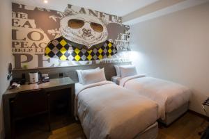 Postel nebo postele na pokoji v ubytování Legend Hotel Kaohsiung Pier2
